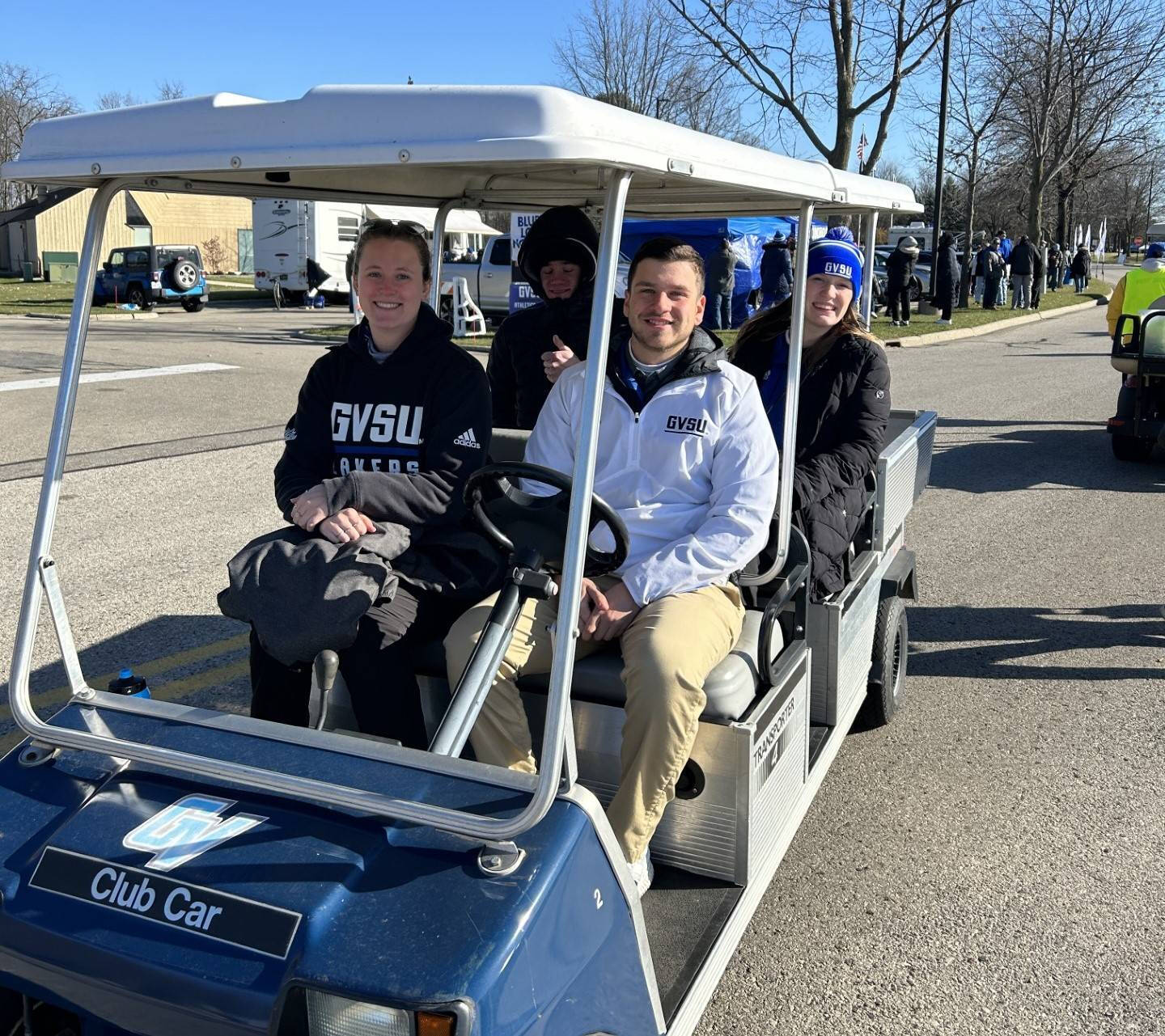 Game Ops team sitting on a golf cart